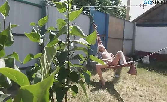 Horny Blonde Masturbates Outdoors in Her Hammock